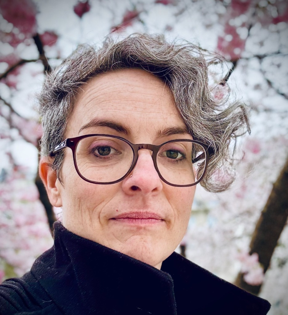 Kelly Webb-Davies portrait under cherry blossoms