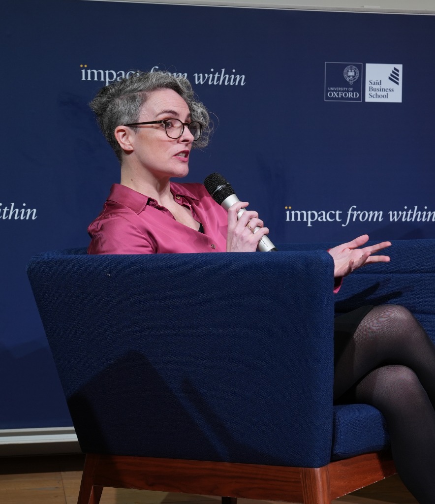 Kelly Webb-Davies sitting down in pink shirt